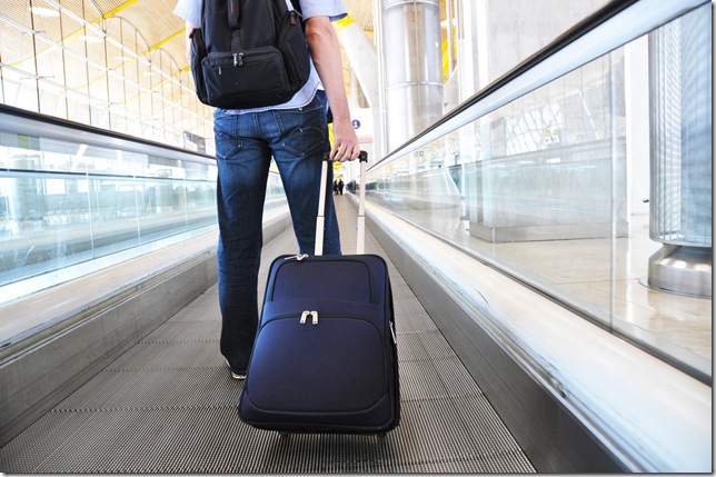 Traveler with a suitcase on the speedwalk; Shutterstock ID 100639087; PO: Bulk re-download due to lost images.