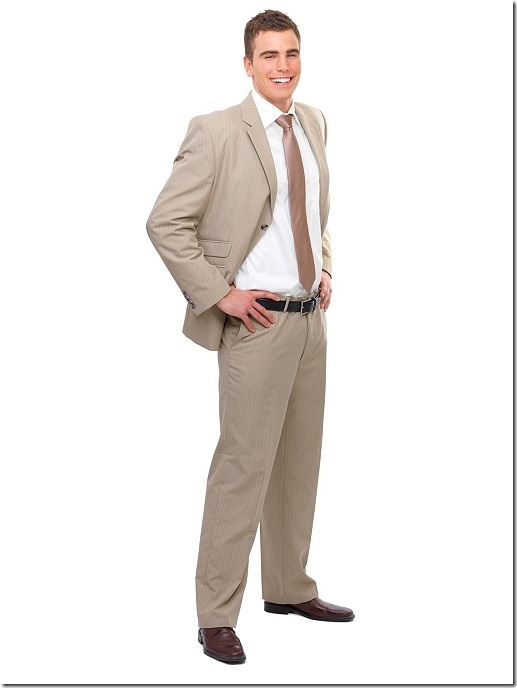 Full Body portrait of a young smiling business man with hands on side.